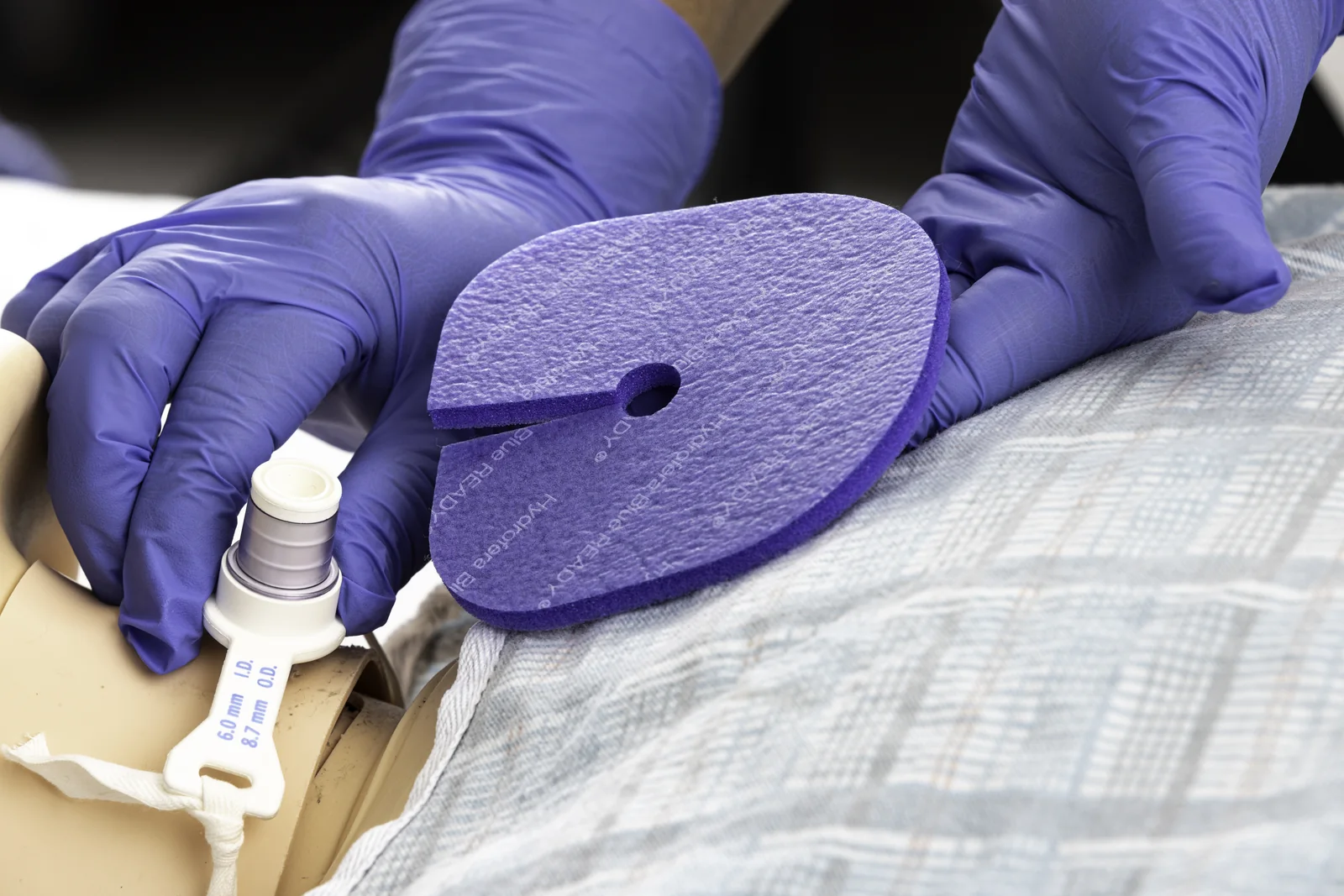 Clinician applying Hydrofera Blue READY Tube Site Dressing